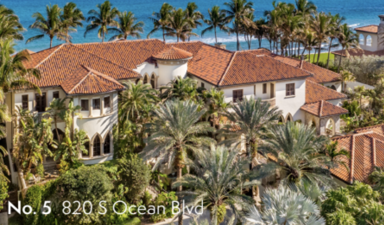 Elegant oceanfront estate at 820 S Ocean Blvd surrounded by palm trees, terracotta roofs, and tropical landscaping overlooking the beach.